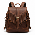 Front view of brown leather backpack with fringe detail.