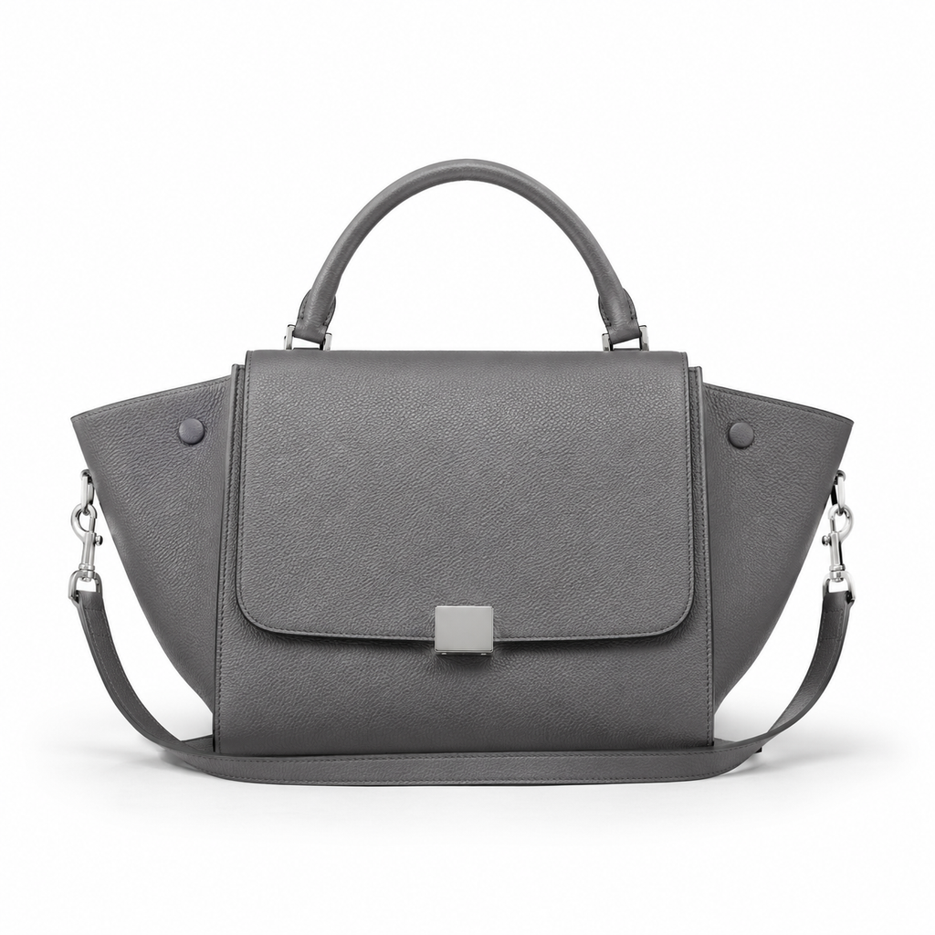 Front view of grey leather handbag with detachable strap.