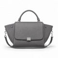Front view of grey leather handbag with detachable strap.