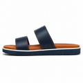 Men's two-tone vegan leather slide sandal in navy and tan with white midsole stripe and tonal tan contrast stitching, three-quarter view