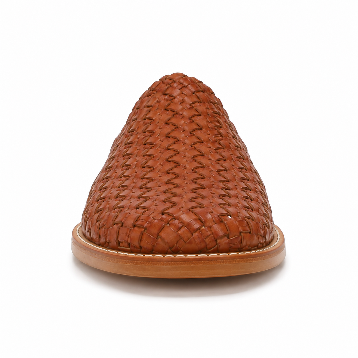 Side profile of men's cognac hand-woven vegan leather mule showing the woven upper and natural tan leather sole