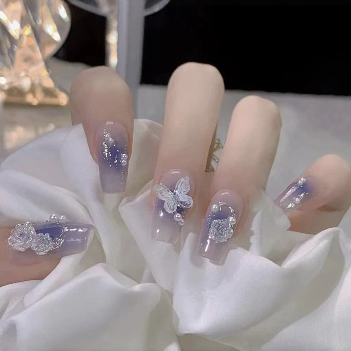Artistic Acrylic Nails with Butterfly Design and Glitter Accents