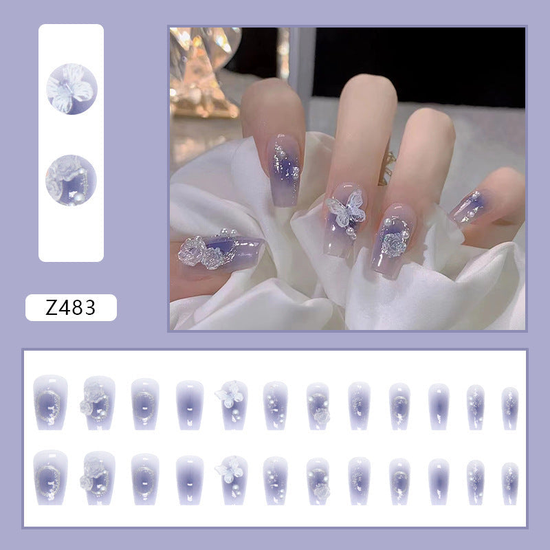 Artistic Acrylic Nails with Butterfly Design and Glitter Accents