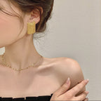 Golden shining city tassel earrings