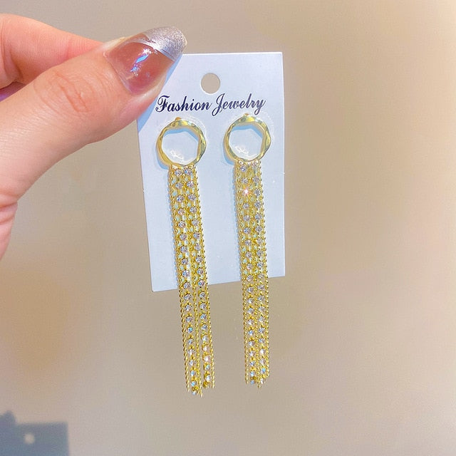 Golden shining city tassel earrings