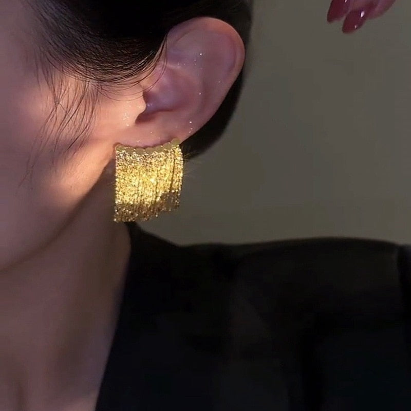 Golden shining city tassel earrings
