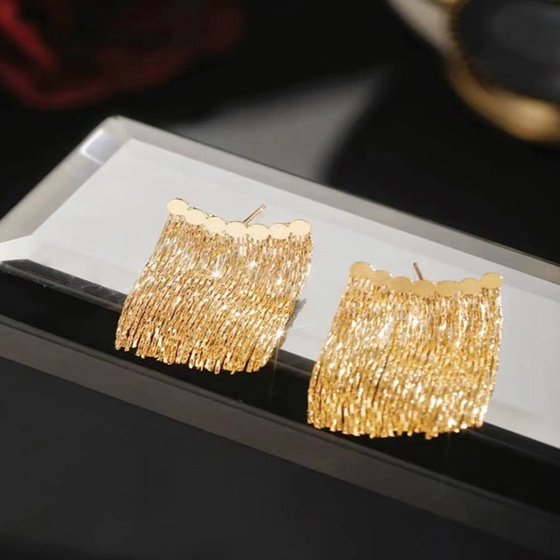 Golden shining city tassel earrings