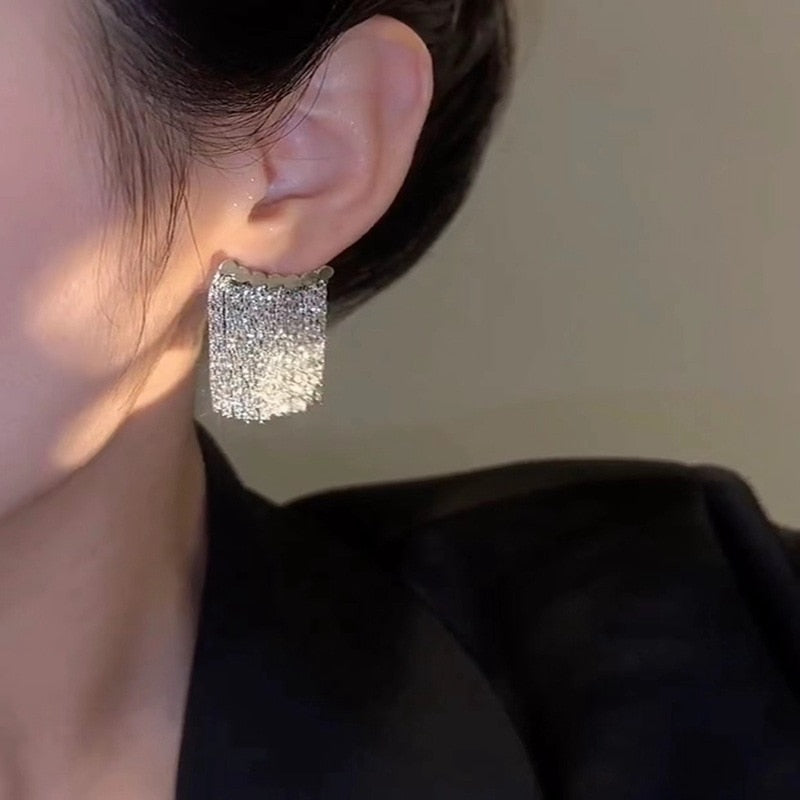 Golden shining city tassel earrings
