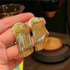 Golden shining city tassel earrings