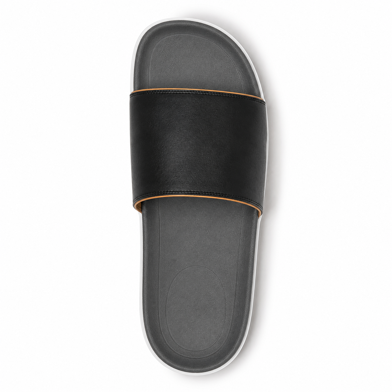 Man wearing matte black single-band vegan leather slide sandals with cropped black trousers on a polished concrete loft floor