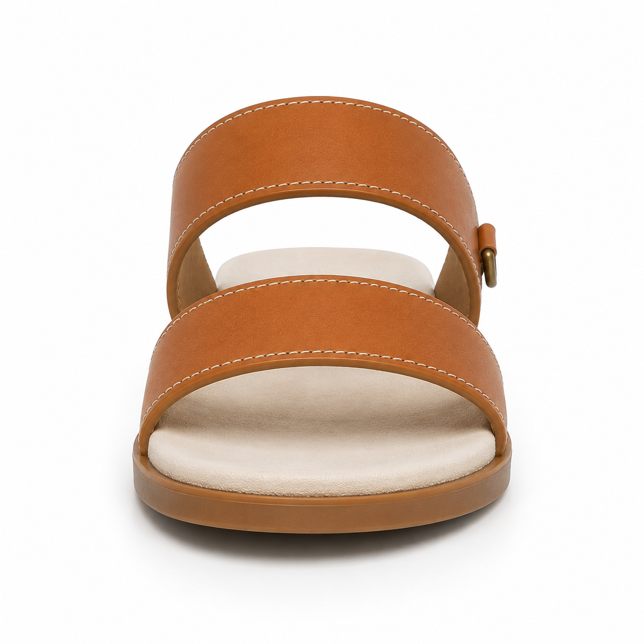 Side profile of women's tan two-strap vegan leather slide sandal showing the antique brass D-ring detail and cream cushioned footbed