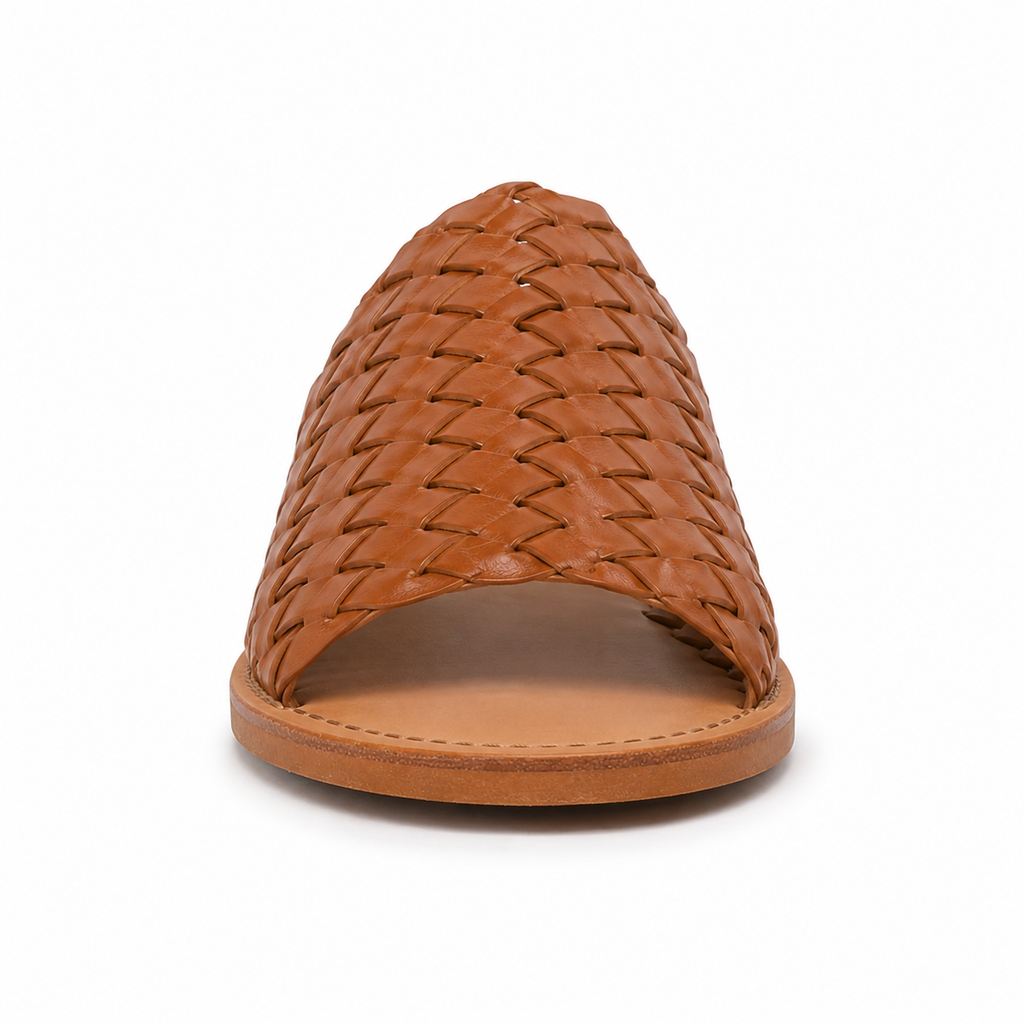 Side profile of women's cognac hand-woven vegan leather slide sandal showing the woven upper and natural tan leather sole