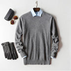 Men's cashmere jumper layered over shirt for smart-casual look