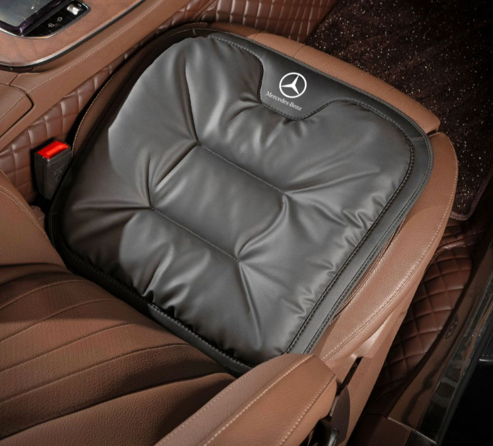 Velario ergonomic car cushion fitted on a car seat providing lumbar support and comfort.