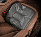 Velario ergonomic car cushion fitted on a car seat providing lumbar support and comfort.