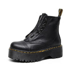 Women's black leather boots with chunky sole, side view showing sleek silhouette and modern design.
