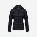 Woman wearing lightweight puffer jacket in natural outdoor setting