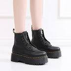 Women's black leather boots with chunky sole, front view highlighting the bold aesthetic and quality craftsmanship.