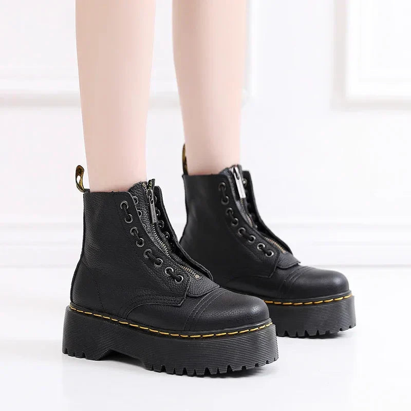 Women's black leather boots with chunky sole, front view highlighting the bold aesthetic and quality craftsmanship.