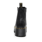 Women's black leather boots with chunky sole, detailed close-up of genuine leather material and durable sole construction.