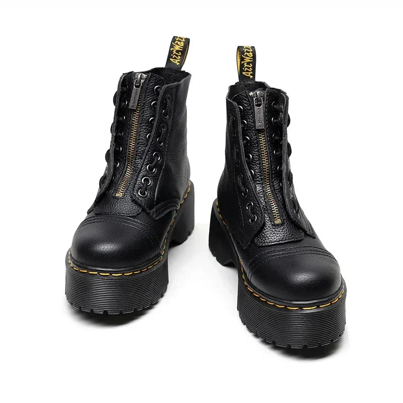 Women's black leather boots with chunky sole, styled with casual outfit demonstrating versatile day-to-night wear.