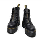 Women's black leather boots with chunky sole, styled with casual outfit demonstrating versatile day-to-night wear.