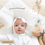 BONEROSHOP Ergonomic Baby Sleep Cushion placed in a cot, showing how it fits perfectly in standard nursery furniture.