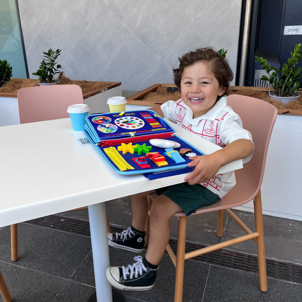 Close-up of Montessori busy board showing various tactile activities and colourful design