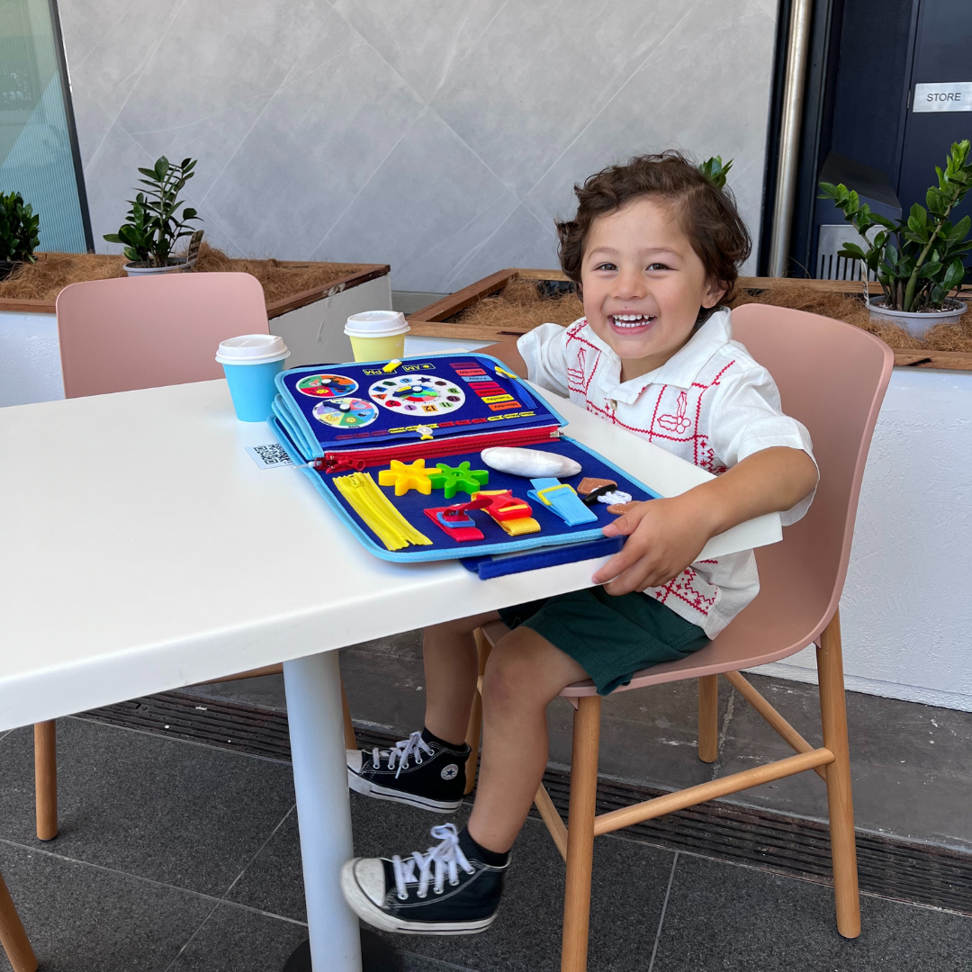 Close-up of Montessori busy board showing various tactile activities and colourful design