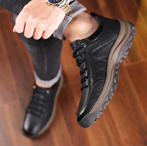 Men's orthopaedic leather boots worn in outdoor setting, demonstrating waterproof performance and all-day comfort.