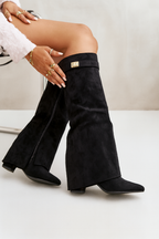 Women's knee-high boots in black leather styled with dress, showing elegant silhouette and stable block heel.