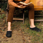 Side view of men's orthopaedic slippers showing supportive structure and decorative stitching
